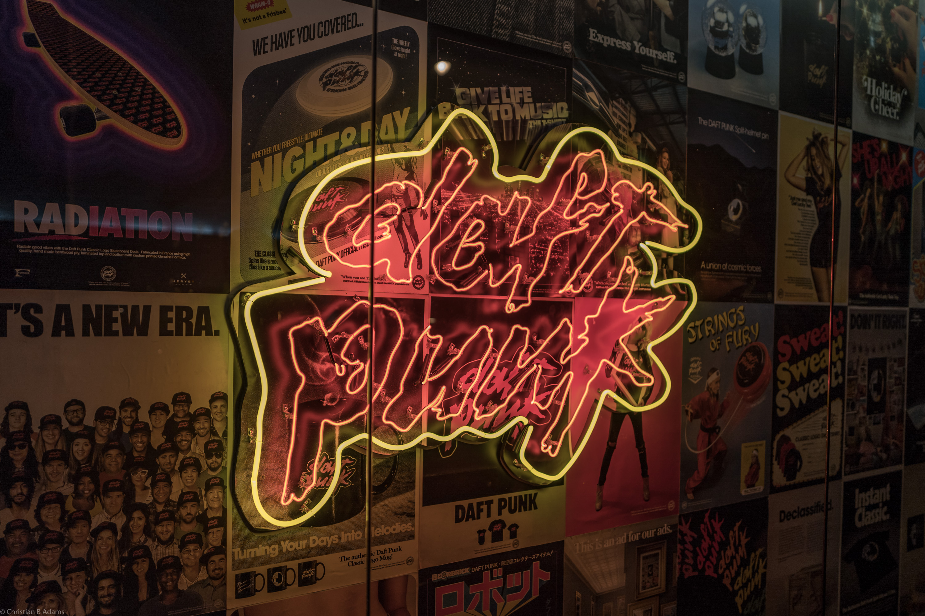 A neon Daft Punk Logo is flanked by posters featuring licensed Daft Punk Merchandise at the Daft Punk Pop Up at Maxfield Gallery in Los Angeles in February of 2017.